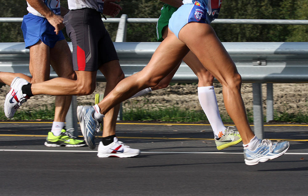 The legs of runners in a race
